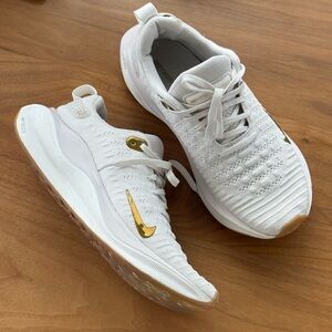 Nike White Women's Flyknit Running Shoes with Gold Swoosh